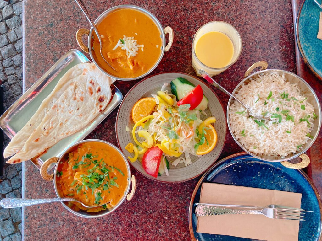 butter chicken curry vegetable curry naan rice lassi salad