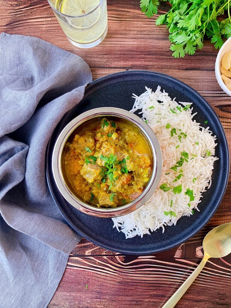 lamb curry white rice coriander linen spoon lemon water